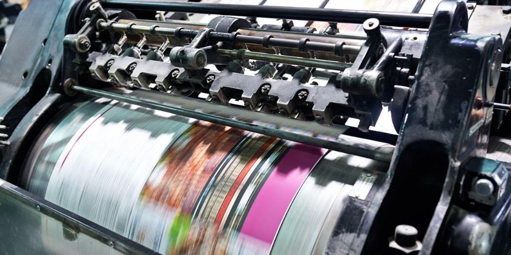 A machine that is printing some type of paper.